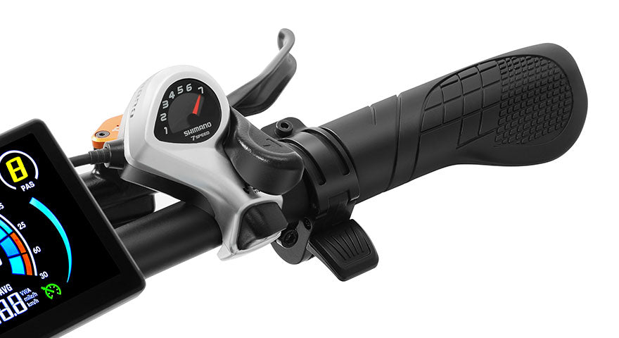 Close-up of a bicycle handlebar with Shimano 7-speed gear shifter, black grip, and digital display